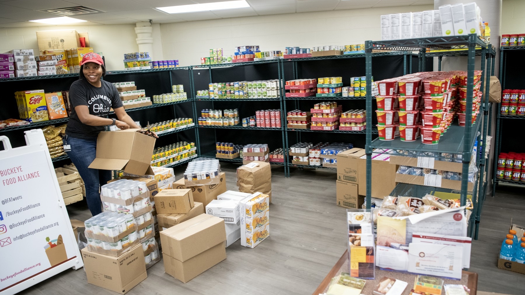 Student Wellness Center team member Michaela Martin unpacks boxes at the Buckeye Food Alliance.