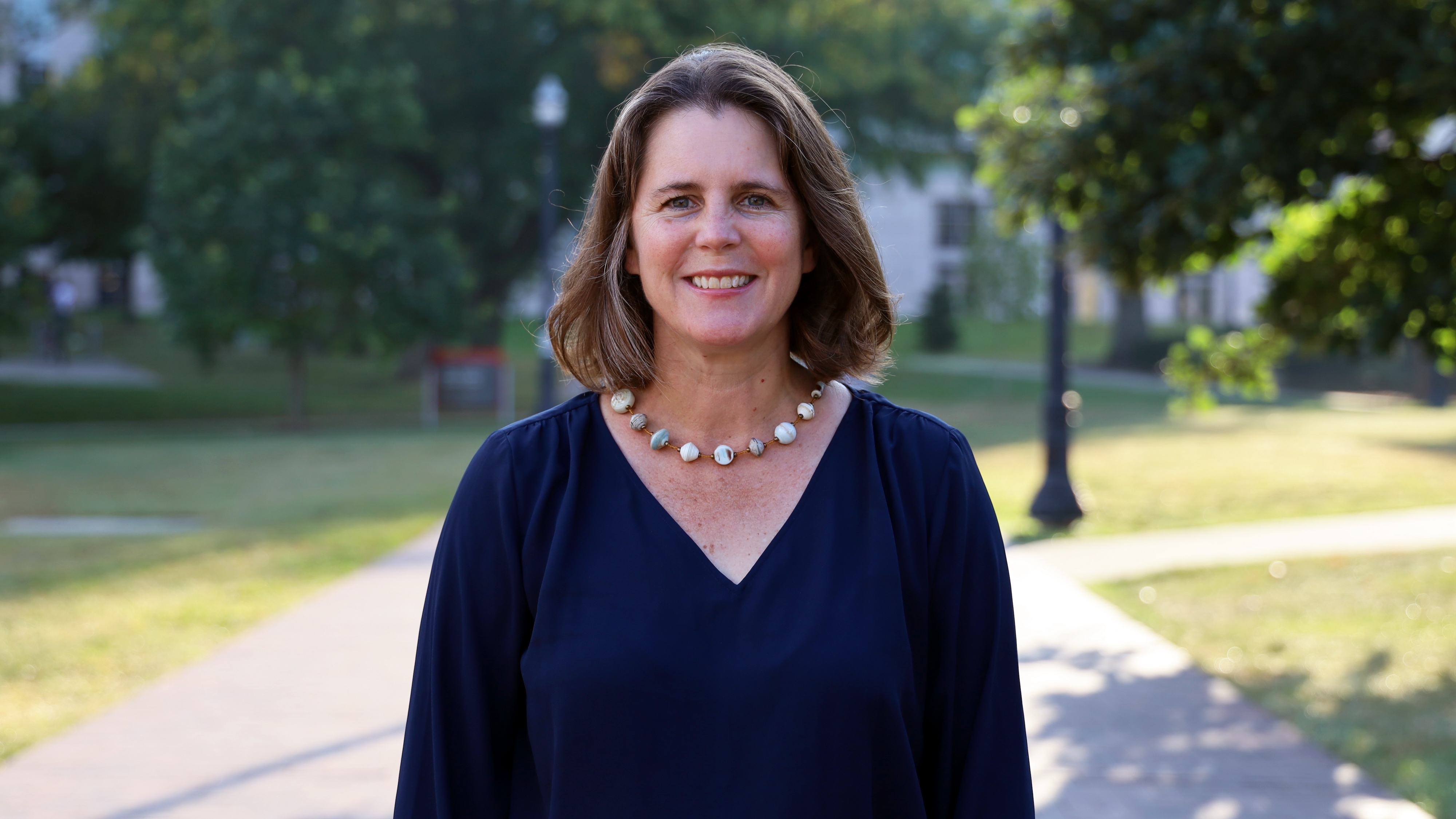 Alison Norris stands outside on campus