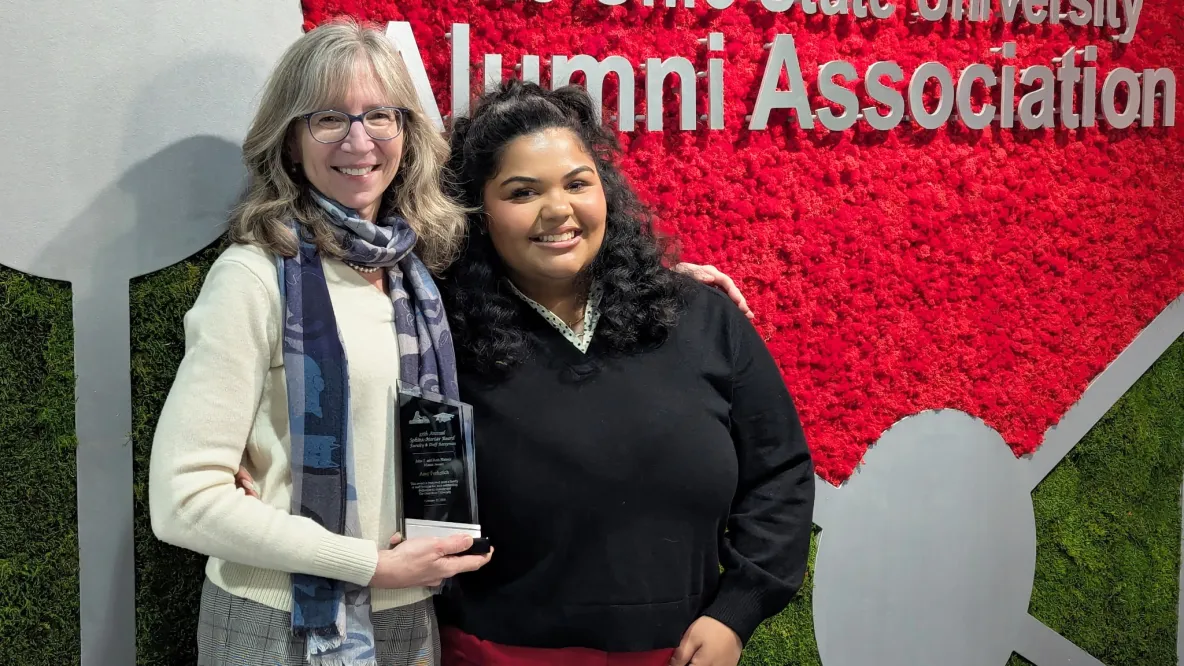 Amy Ferketich and Emma Guess. Amy holds an award.