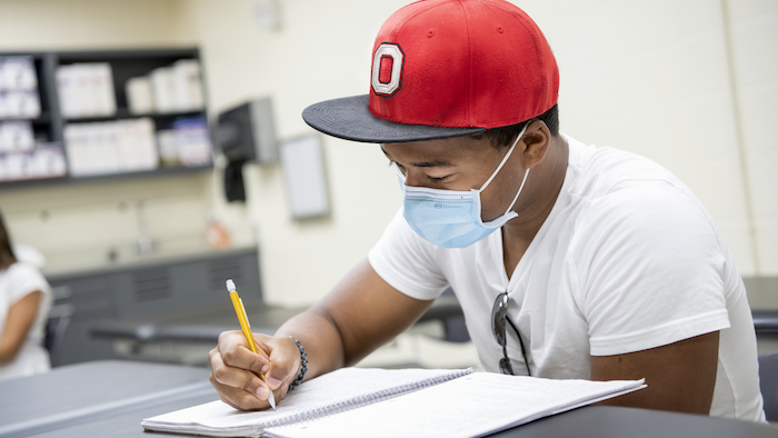 student studying wearing mask