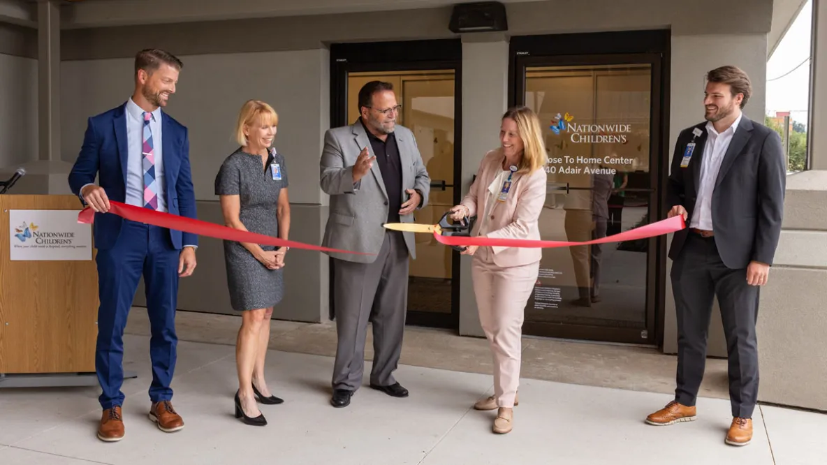 People cut ribbon to open new healthcare facility