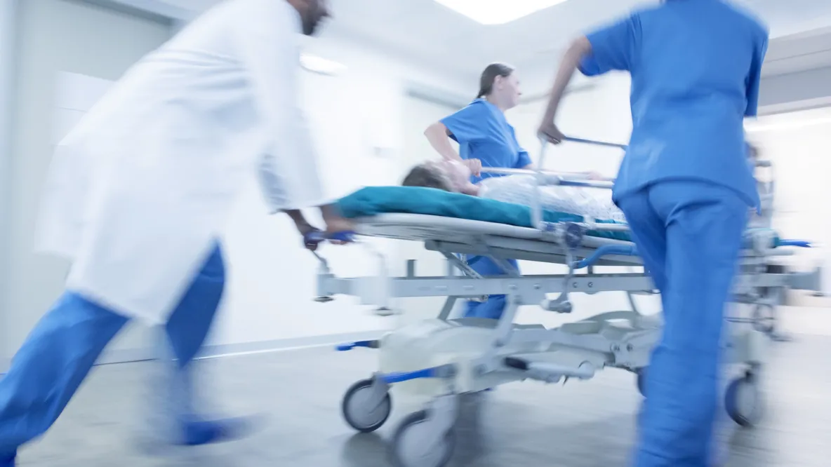 Medical team rushing into hospital with patient on a stretcher