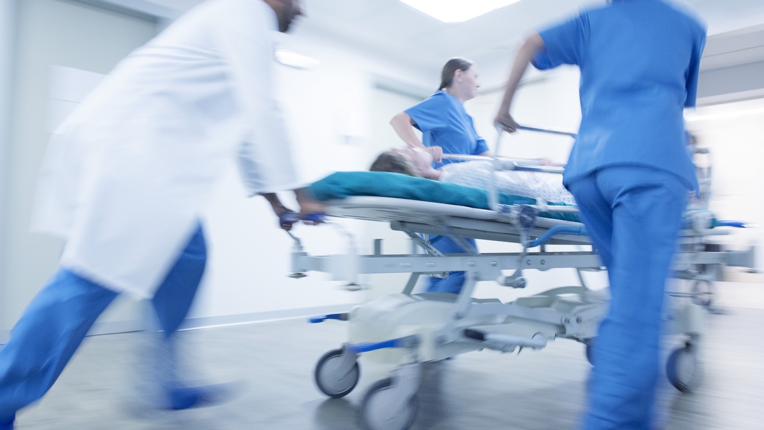 Medical team rushing into hospital with patient on a stretcher