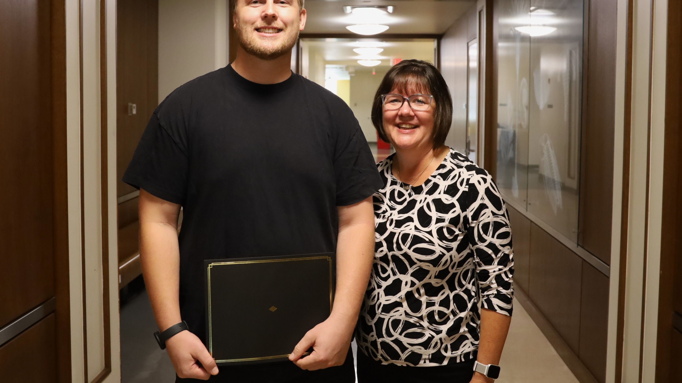 Jonathan Schmidt with Kelly Scheiderer holding his award
