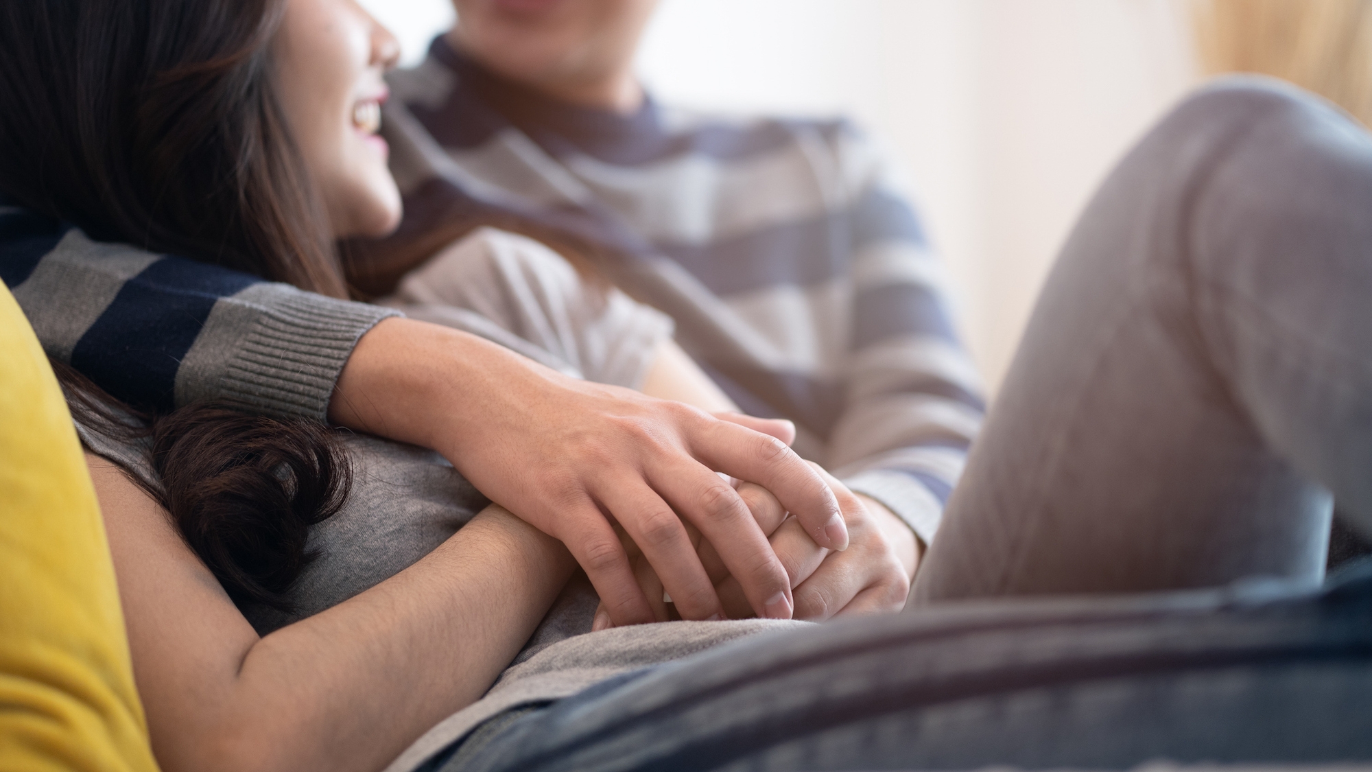 Couple on couch hugging