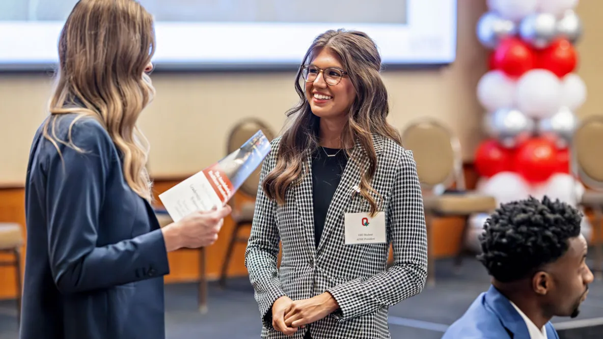 MHA students talk to each other at a leadership event