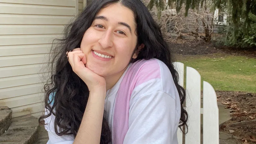 Monica sitting outside smiling