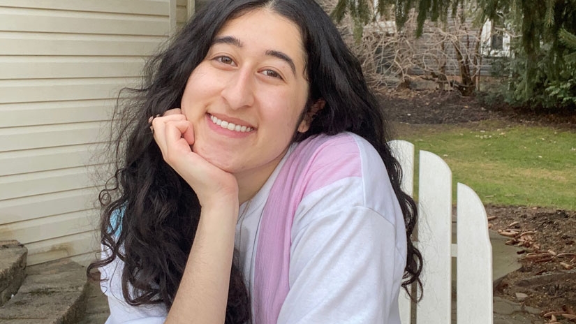 Monica sitting outside smiling