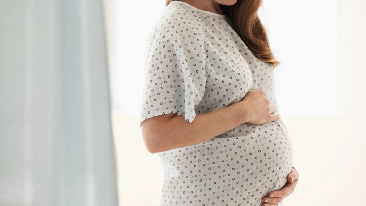 pregnant woman standing in hospital room