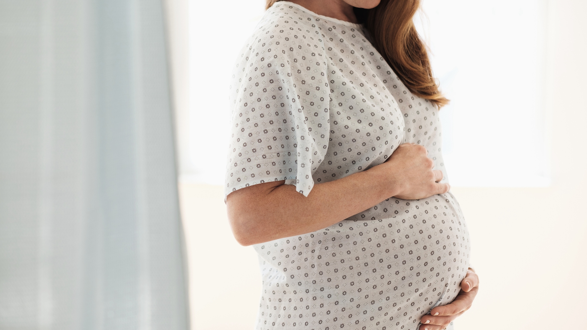 pregnant woman standing in hospital room