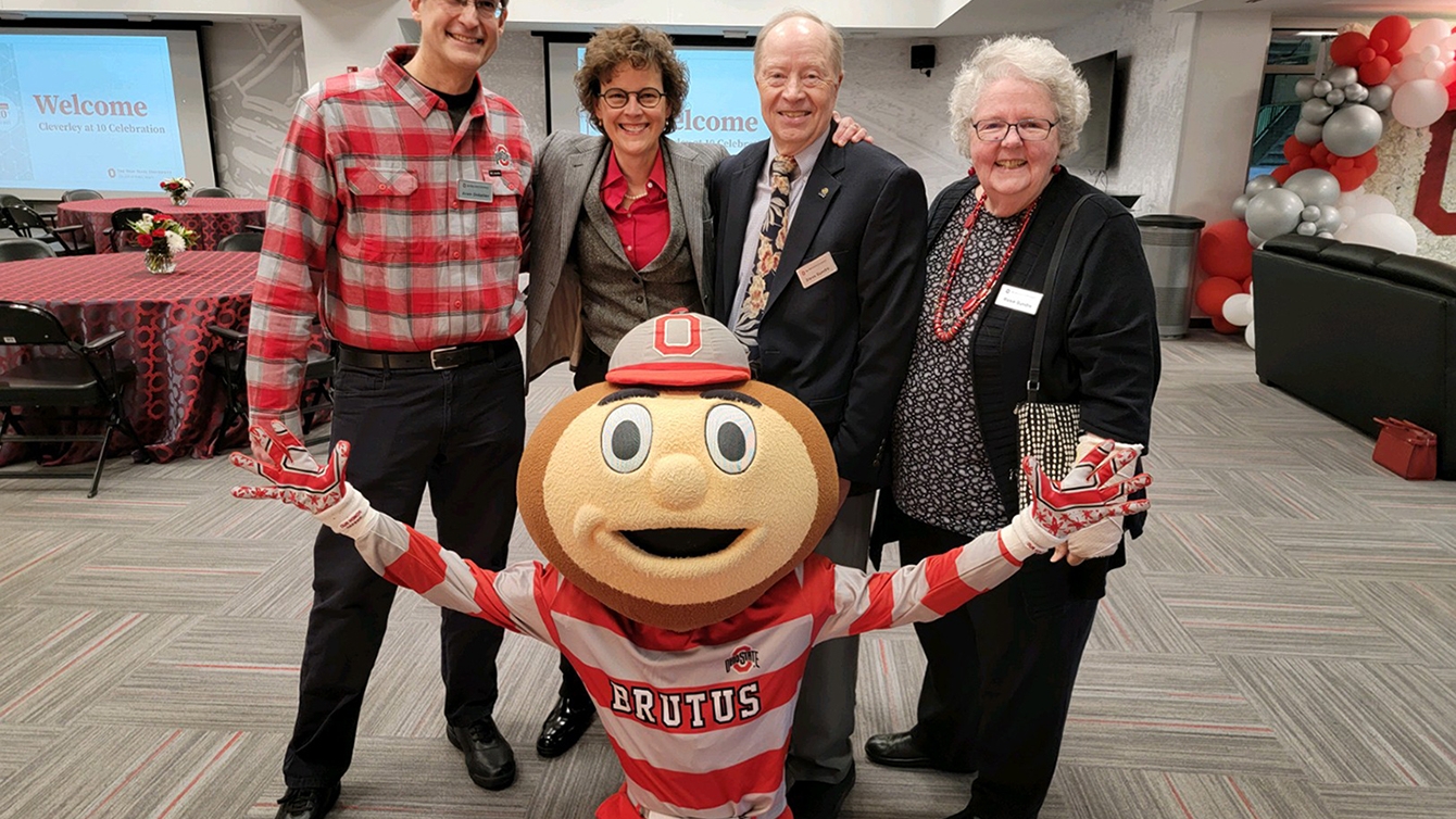 Cleverly at 10 attendees smile for a photo with Brutus