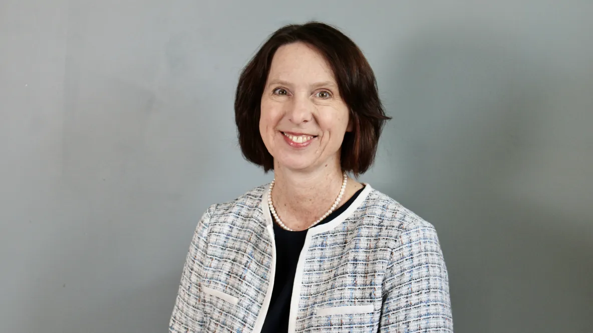 Robin Puett, posed in front of gray background