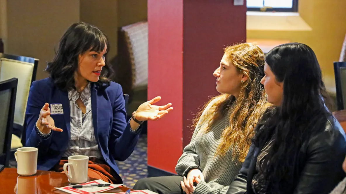 Two students networking with a CPH alumnae