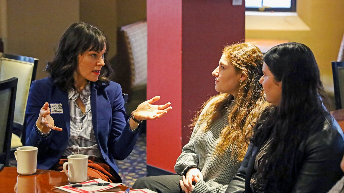 Two students networking with a CPH alumnae