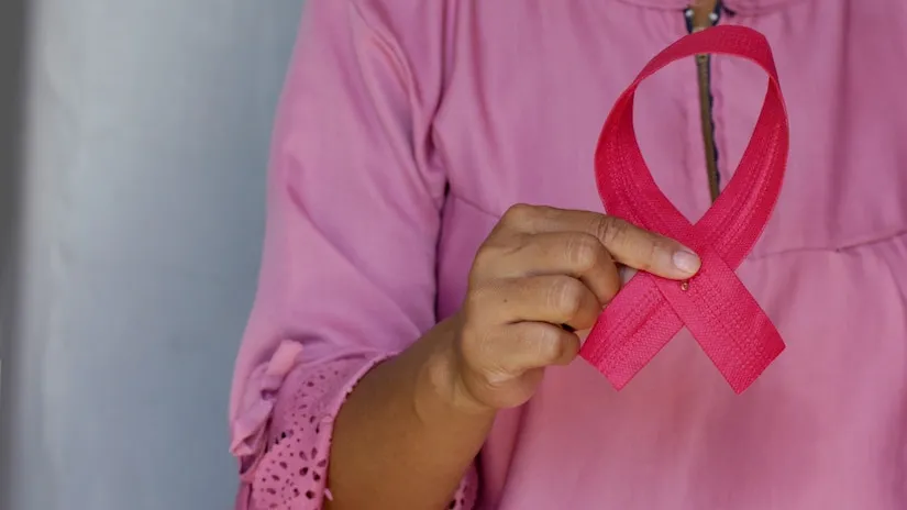 woman holding cancer ribbon