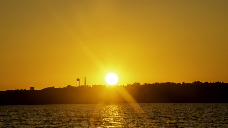 sun setting over city