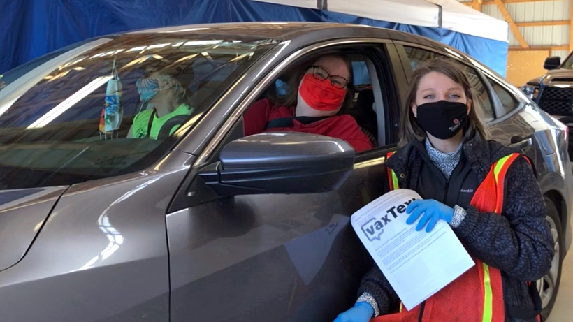 Kate Wright (right) works at a drive-through vaccine clinic for her job as an epidemiologist for Union County Health Department