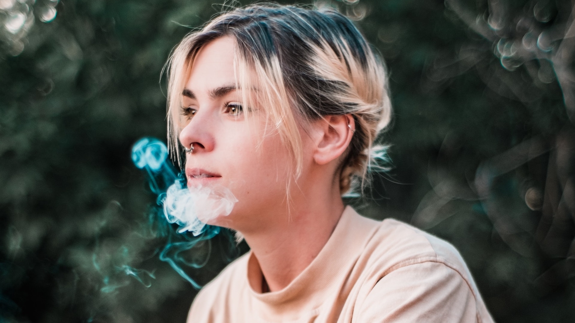 young woman with e-cigarette smoke