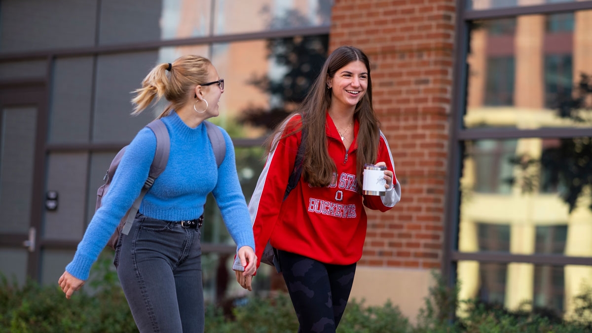 Two women walk along Ohio State's Columbus campus.