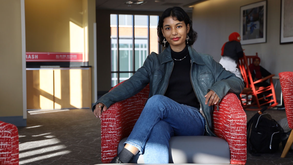 Oshin Samuel sitting in a chair located in a sun-lit study room of the Ohio Union