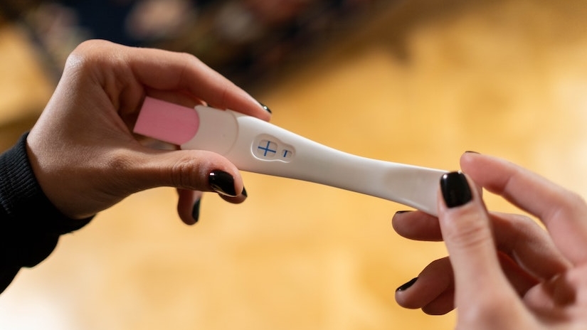woman holding pregnancy test