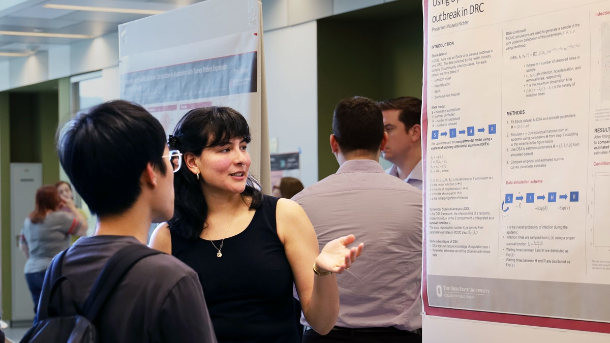 Graduate student shares research results at a college poster competition