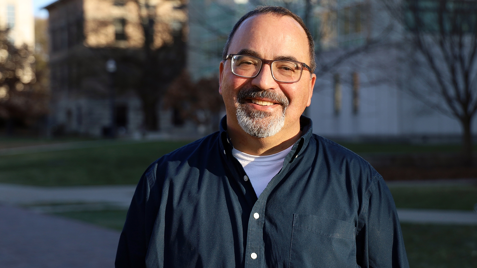 Photo of Paul Matherny smiling. He is wearing glasses and a blue shirt.