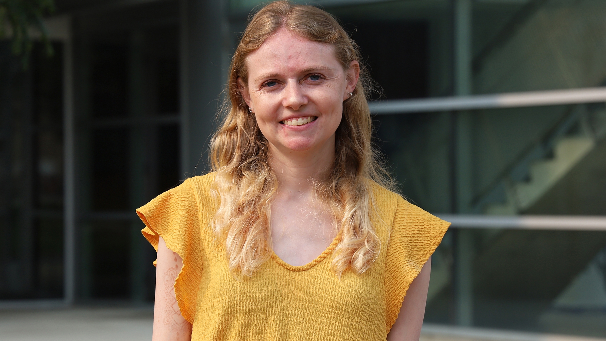 Rachel Saadey smiles in front of Cunz Hall.