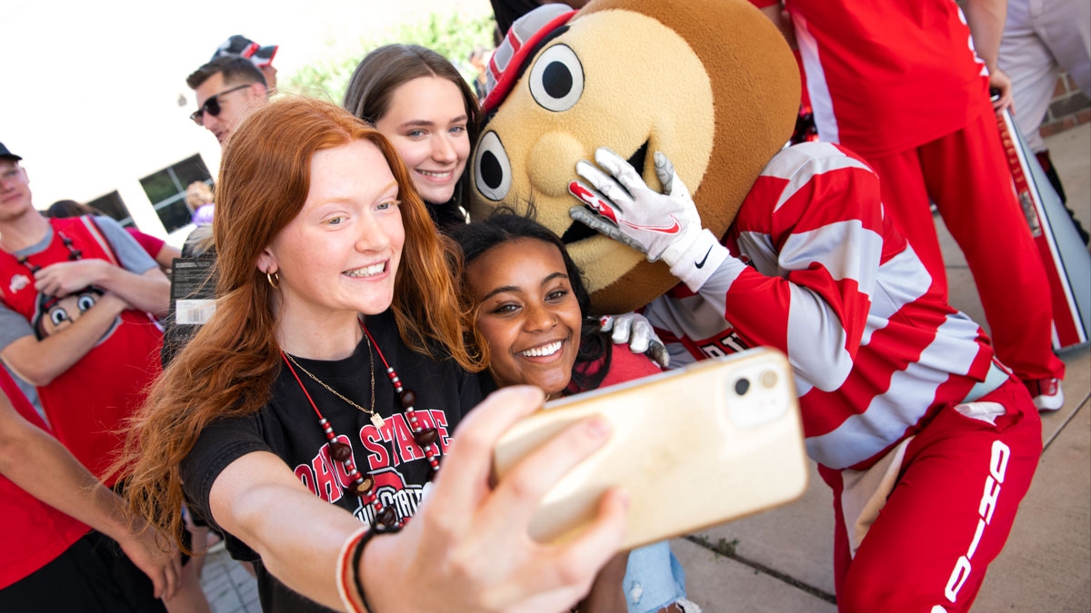 Ohio state students take a selfie with Brutus Buckeye