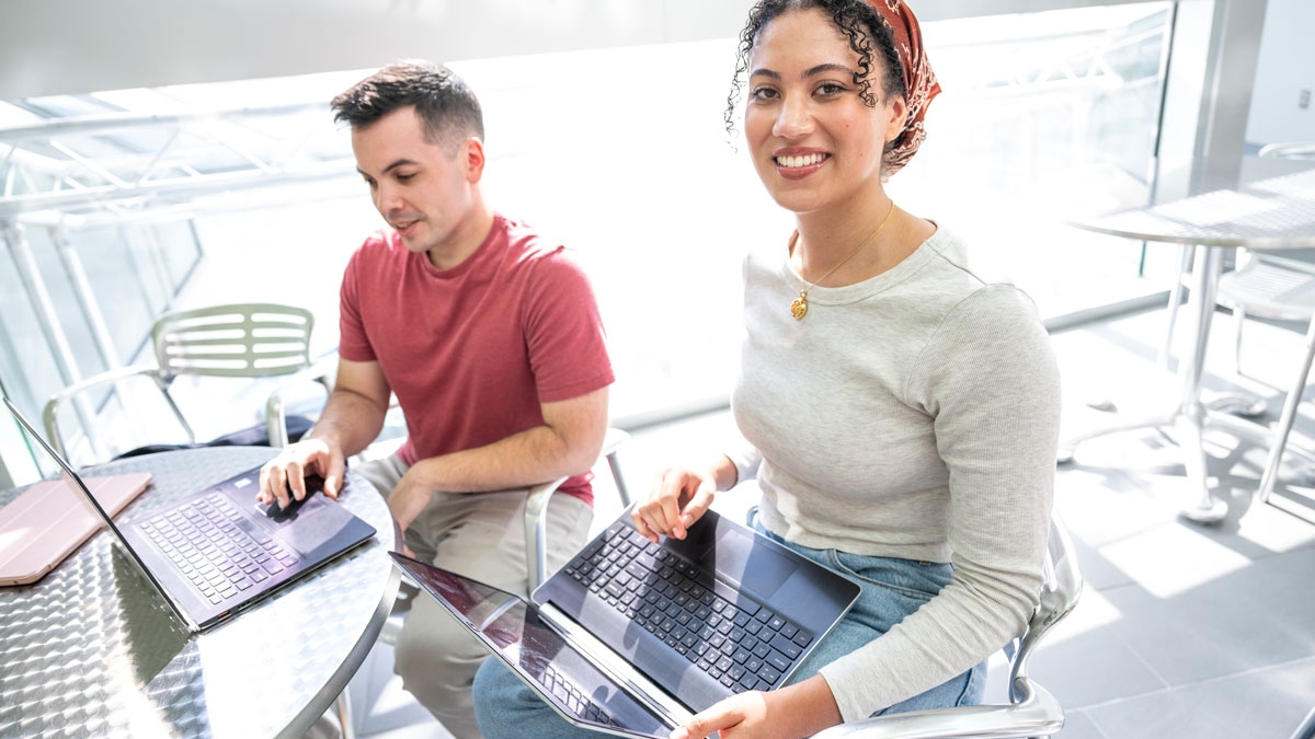 Two students on computers studying in Cunz Hall