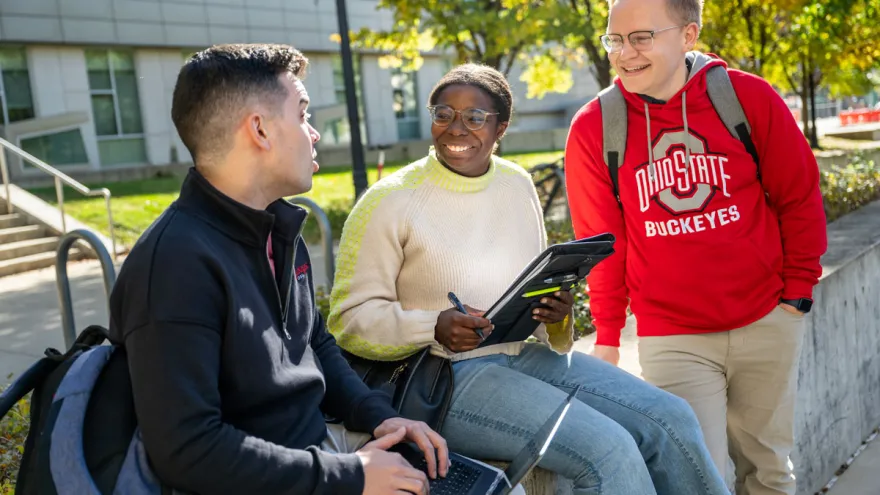 Three public health students talk outside of Cunz Hall