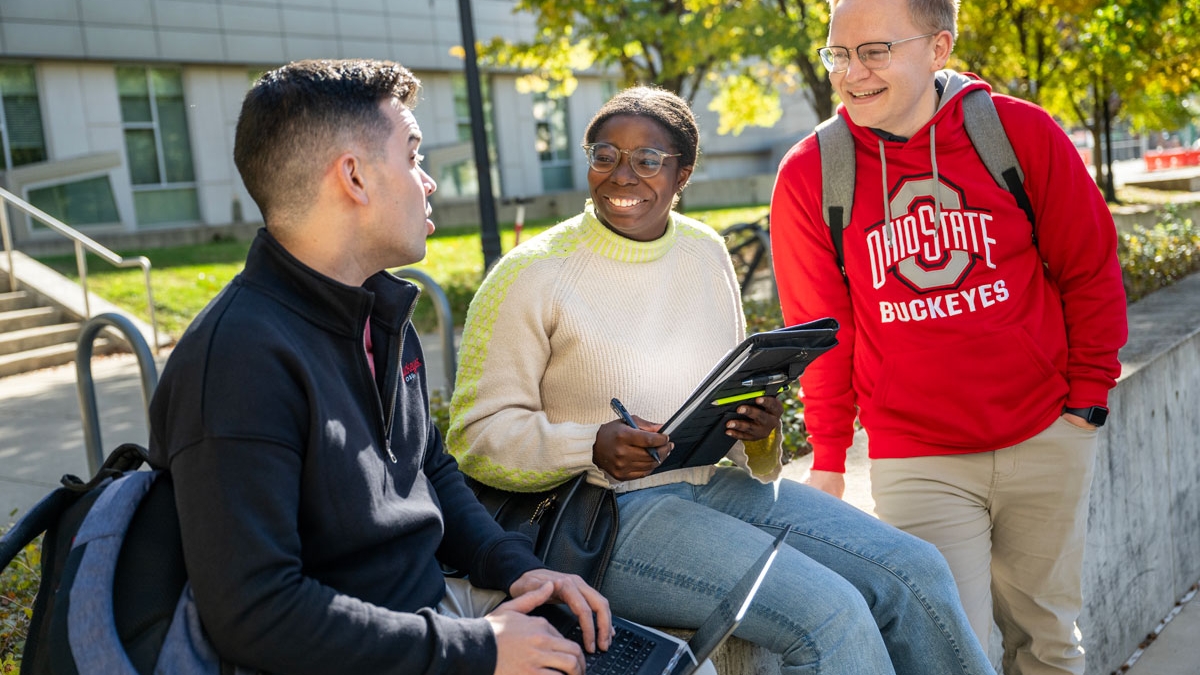 Three public health students talk outside of Cunz Hall