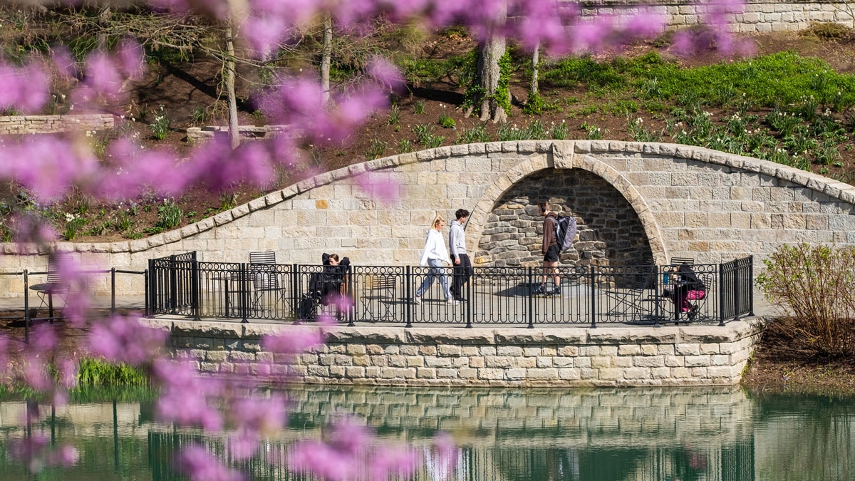 Students walk along Mirror Lake on Ohio State's Columbus campus