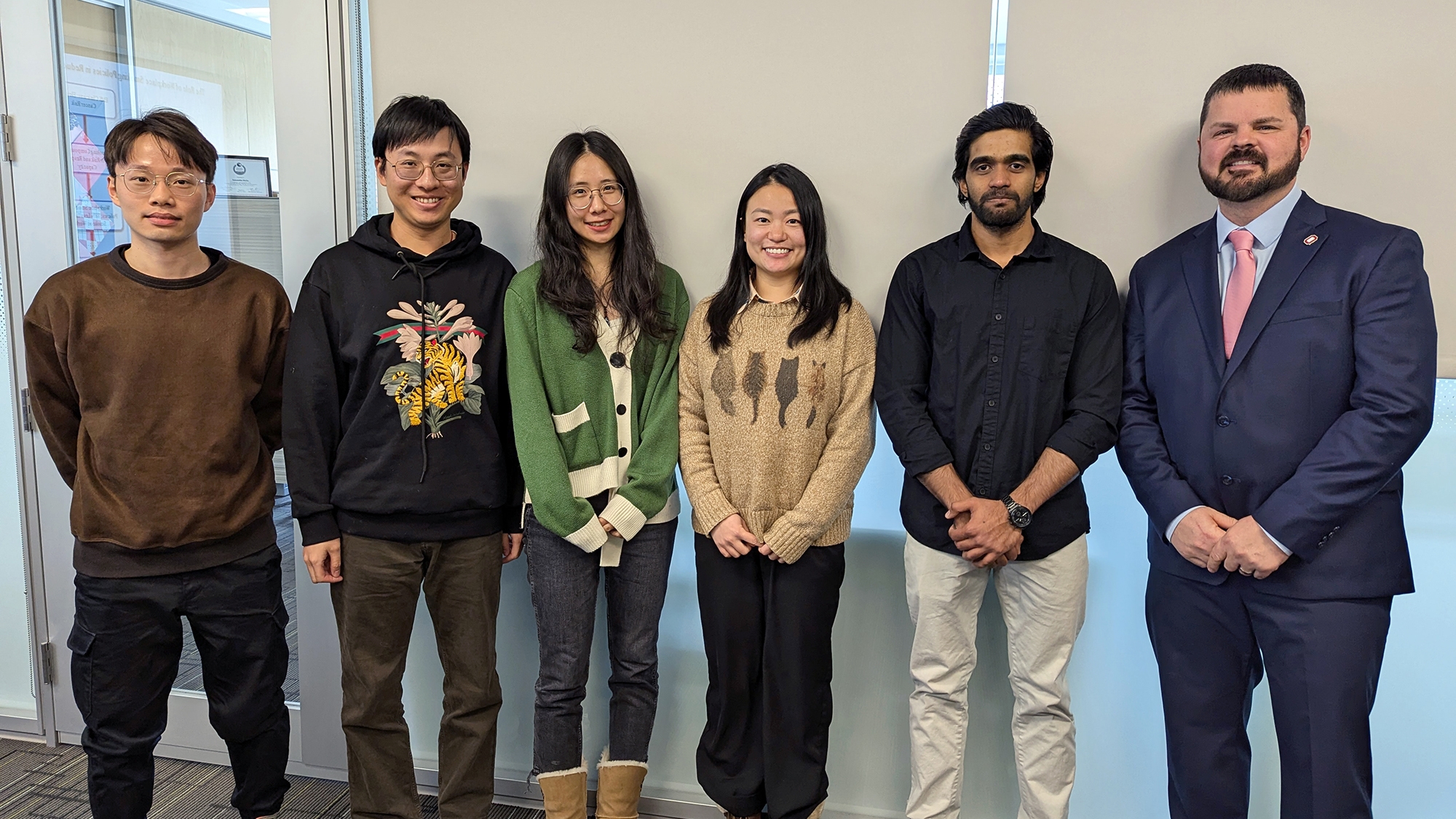 Students who competed in the Three Minute Thesis competition pose for a photo
