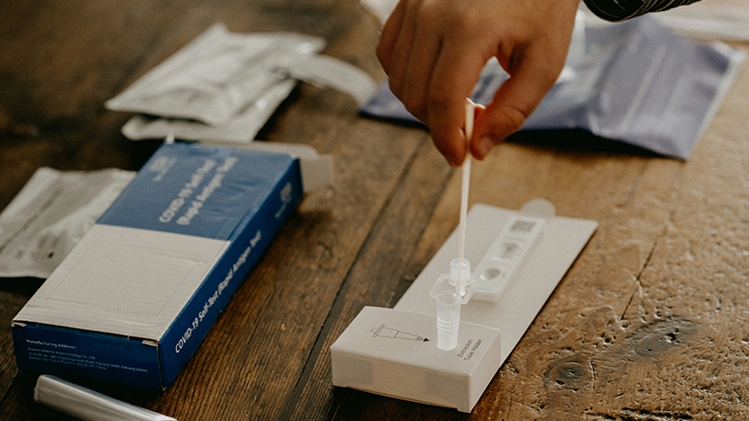 A person administers a COVID-19 test.