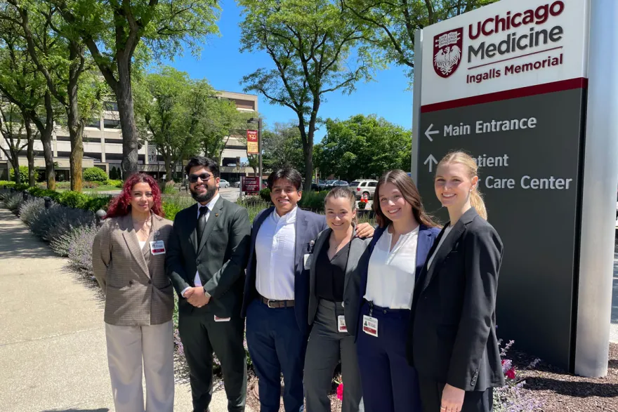 Administrative residency students stand in front of the UChicago Medicine sign