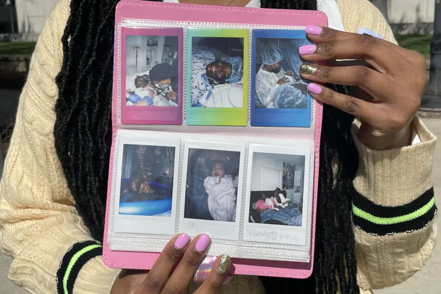 Summernickol Stewart holds a book of photos from her doula work 