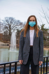 Kelsie Parker standing near fountain wearing mask