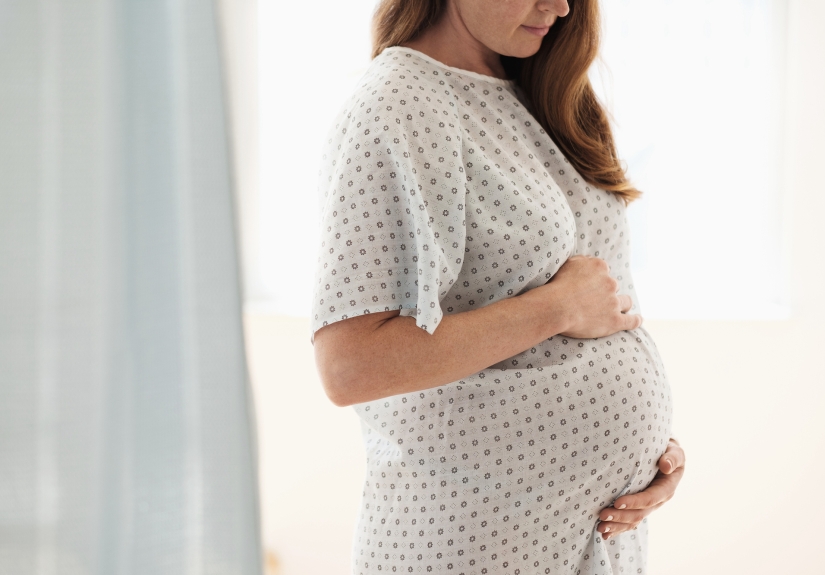 pregnant woman standing in hospital room