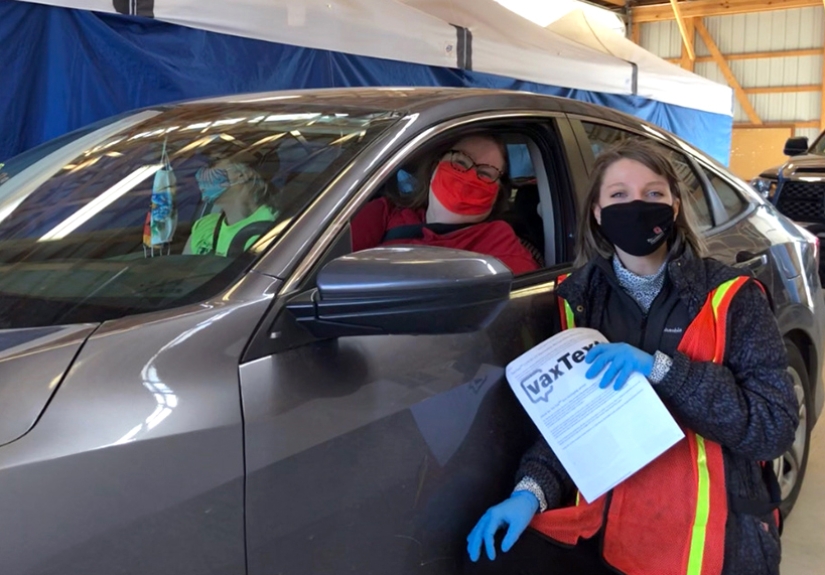 Kate Wright (right) works at a drive-through vaccine clinic for her job as an epidemiologist for Union County Health Department