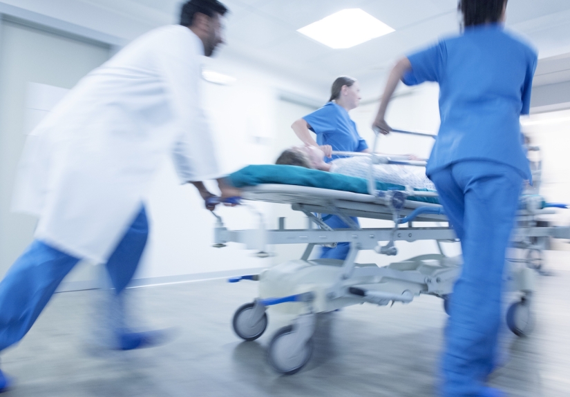 Medical team rushing into hospital with patient on a stretcher