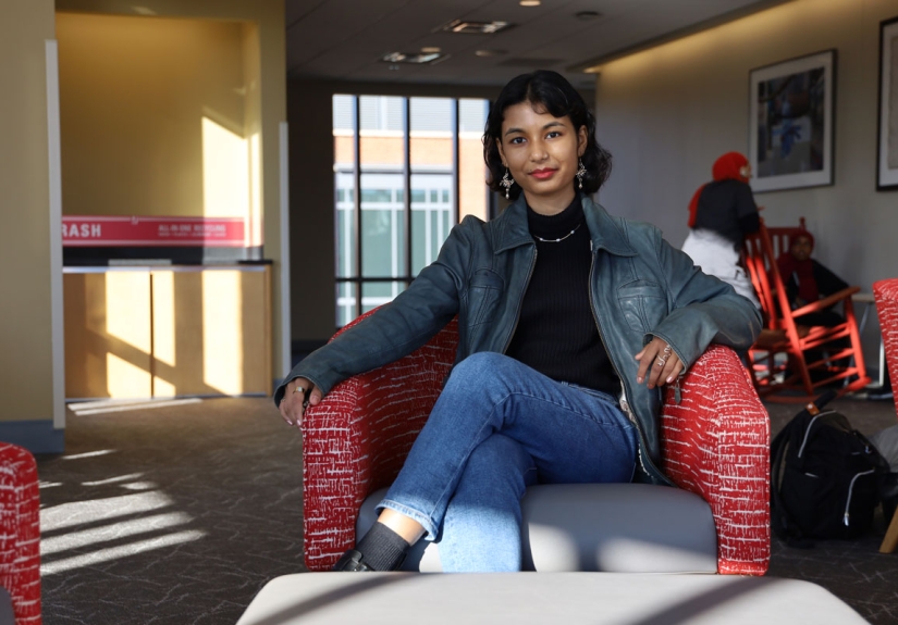 Oshin Samuel sitting in a chair located in a sun-lit study room of the Ohio Union