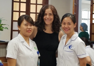 Maria Gallo, PhD, with health care team at Hanoi Hospital in Vietnam.