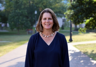 Alison Norris stands outside on campus