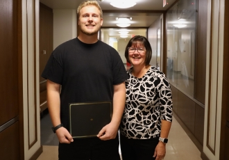 Jonathan Schmidt with Kelly Scheiderer holding his award