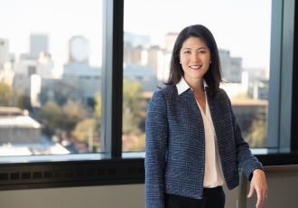 Dr. Paula Song stands by a window