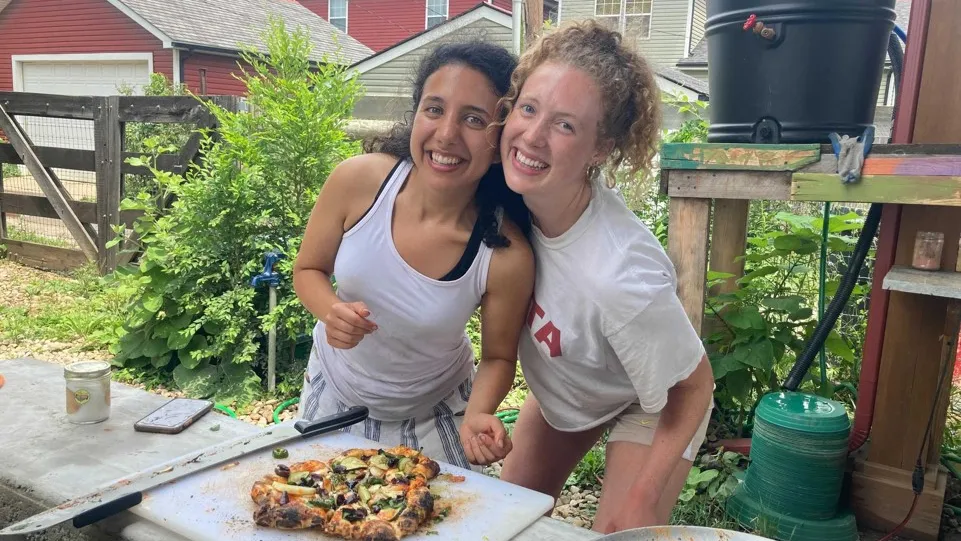 Two students in the community for their capstone internship